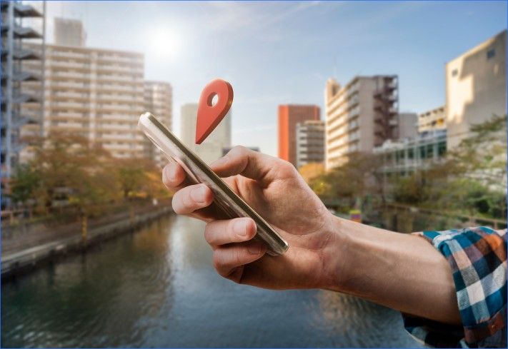 Close-up of printed documents being scanned on a smartphone, showing blurred text and paper alignment during digitisation.