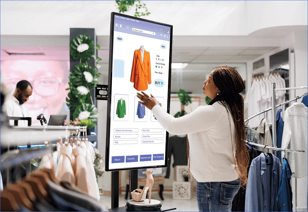 Customer interacting with a digital screen in a clothing store to browse and select products, representing smart retail and interactive visual merchandising.