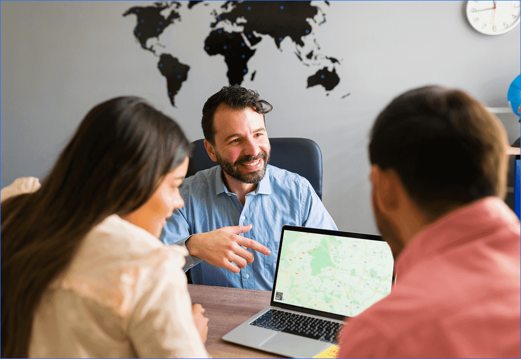 Marketing team discussing location-based marketing strategy using digital maps and customer location data