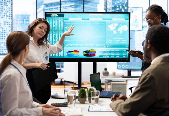 Team reviewing digital analytics dashboard in a modern office setting.